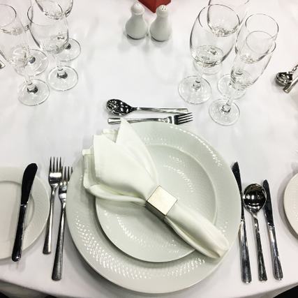 Party & EventsAn arial view of a set table with plates, linens, silverware and glassware.